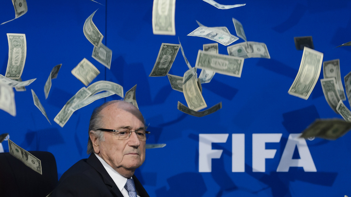 FIFA president Sepp Blatter looks on with fake dollars note flying around him thrown by a protester during a press conference at the football's world body headquarter's on July 20, 2015 in Zurich. FIFA said Monday that a special election will be held on February 26 to replace president Sepp Blatter. AFP PHOTO / FABRICE COFFRINI (Photo credit should read FABRICE COFFRINI/AFP/Getty Images)